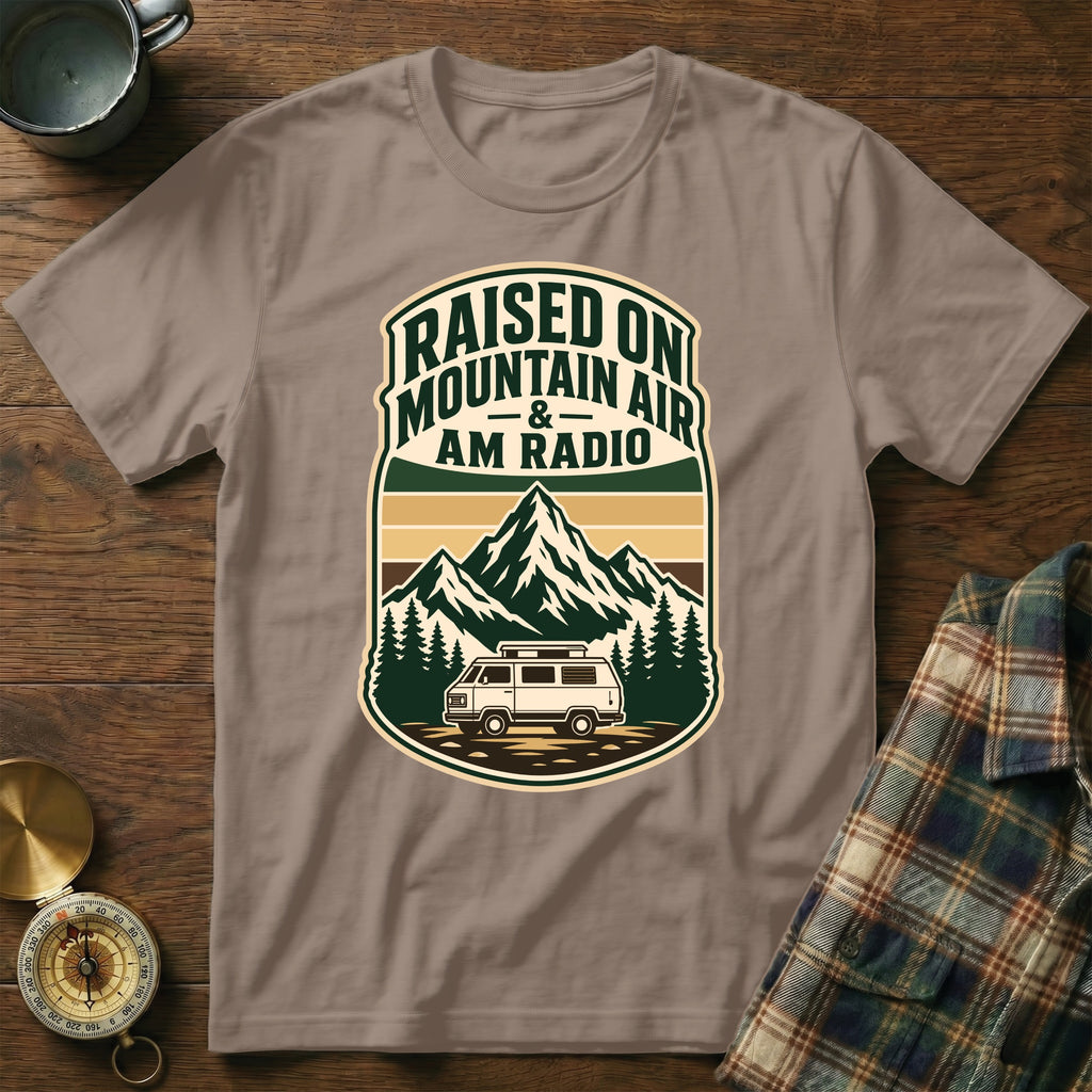 T-shirt with "Raised on Mountain Air & AM Radio" text and mountain van graphic.