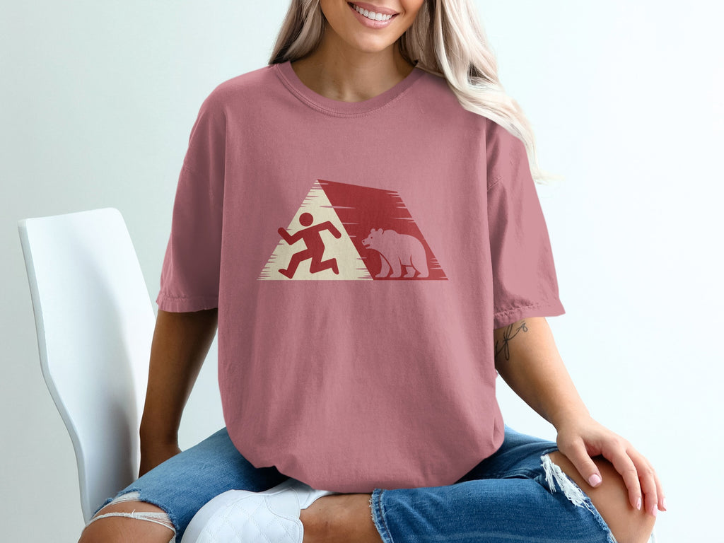 Runner and bear silhouetted against a red and white triangular mountain graphic.