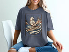 Eagle surfing with lighthouse and trees on a rocky coast.