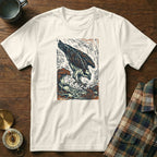 White t-shirt with woodgrain and plaid background, featuring an osprey diving into waves.