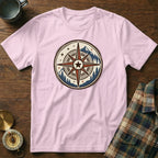 Pink t-shirt with a circular compass design featuring a mountain and tree landscape.