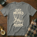 Hermit crab graphic with text "JUST MOVED AGAIN" on a gray t-shirt.