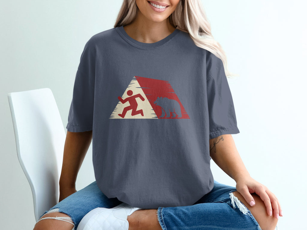 Runner and bear silhouette within a red and white geometric mountain design on a t-shirt.