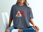 Runner and bear silhouette within a red and white geometric mountain design on a t-shirt.