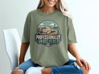 Green t-shirt with a graphic of a seal on a dock with the text "Professionally Unbothered".