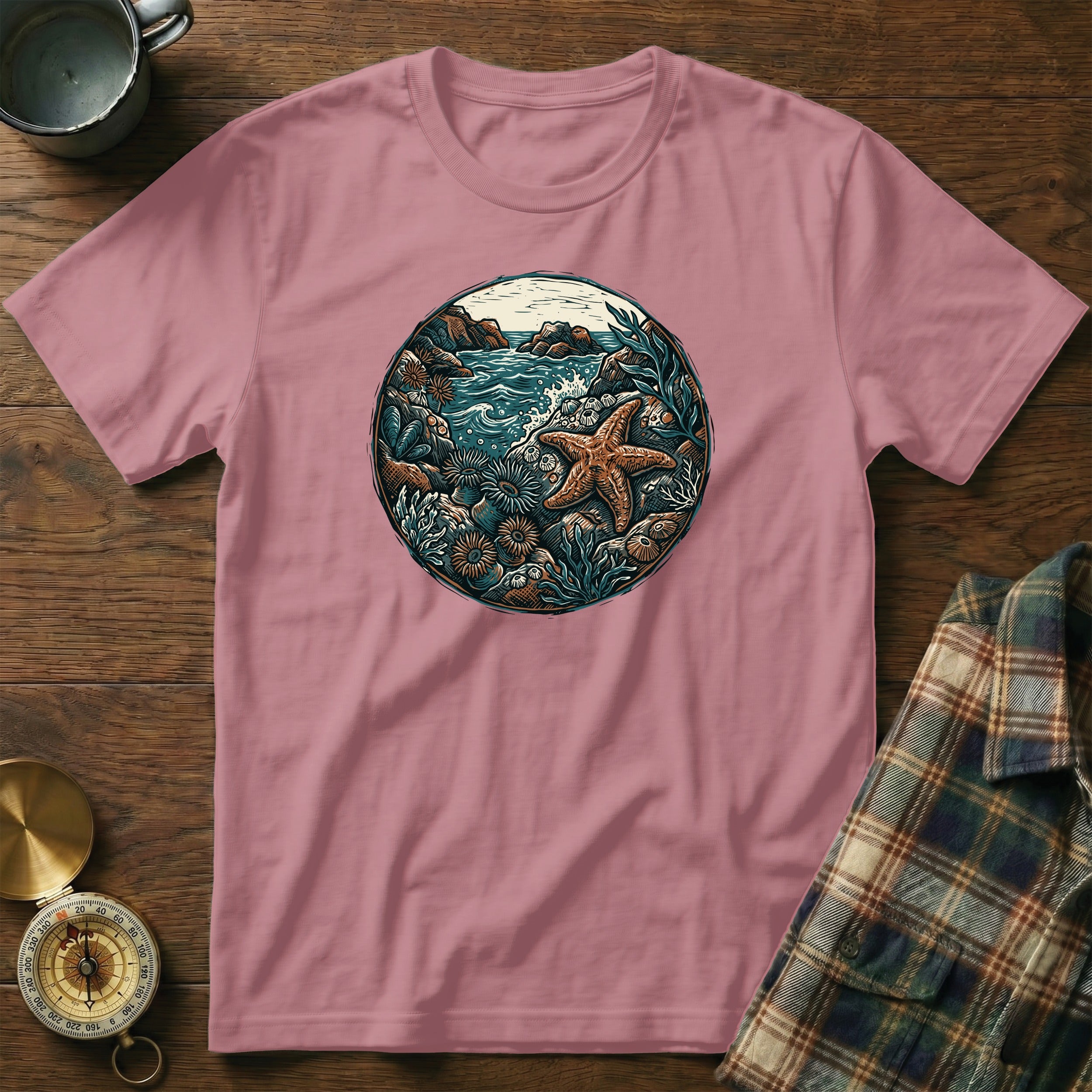 Pink t-shirt with circular ocean scene featuring a starfish and coral.
