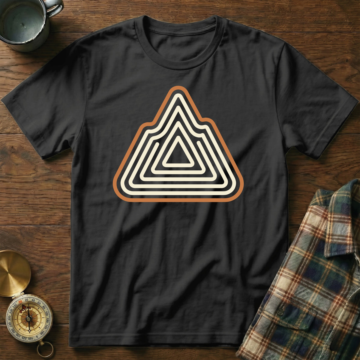 Black t-shirt with a stylized mountain range logo in beige and orange stripes.