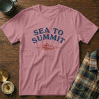 Pink t-shirt with "Sea to Summit" text and wave/mountain graphic.