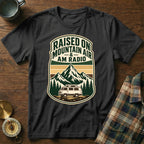 Black t-shirt with "Raised on Mountain Air & AM Radio" text and mountain/van graphic.