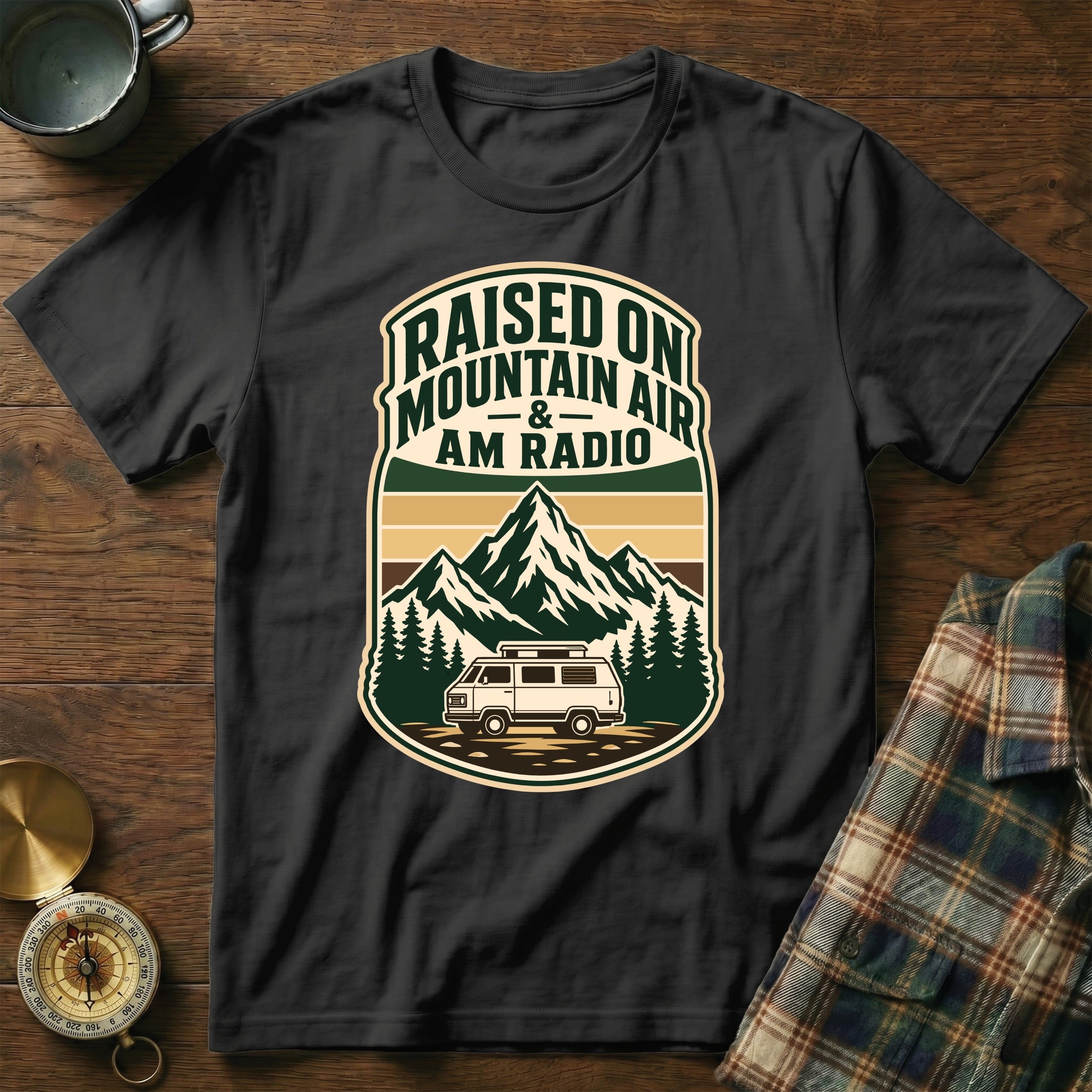 Black t-shirt with "Raised on Mountain Air & AM Radio" text and mountain/van graphic.