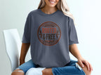 T-shirt with "ROOTED & FREE" text in a circular emblem.