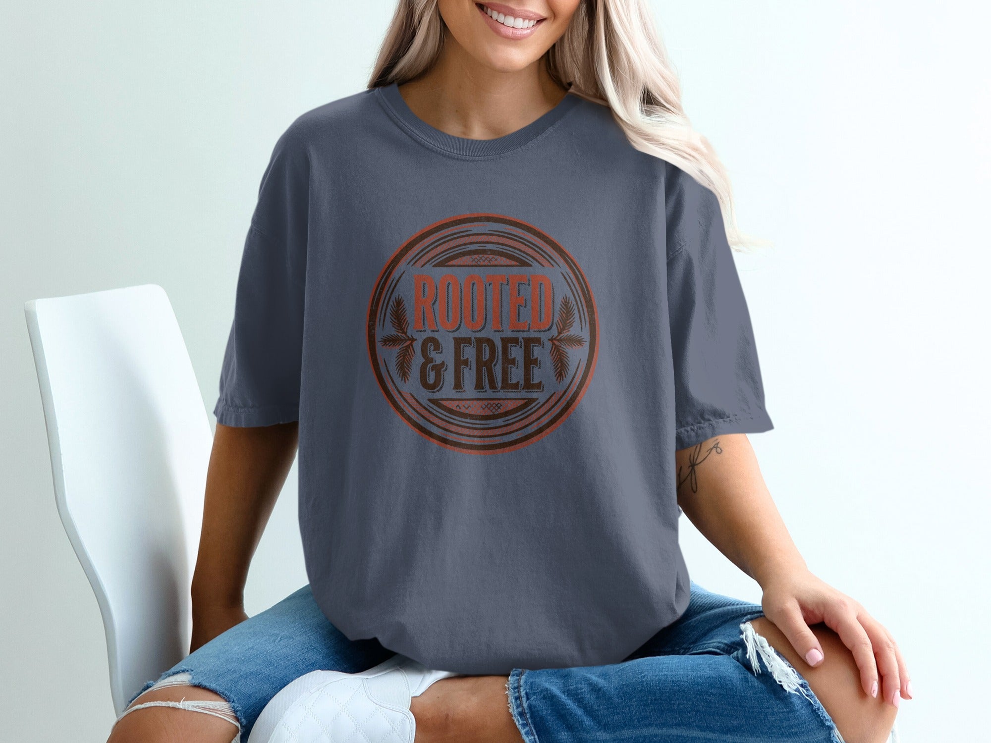 T-shirt with "ROOTED & FREE" text in a circular emblem.