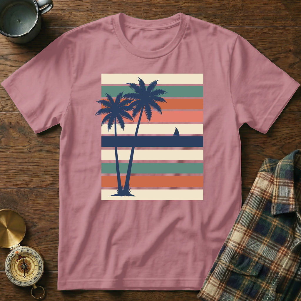 Pink t-shirt with vintage striped sunset and palm trees graphic.