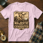 Pink t-shirt with "Majestic But Exhausted" text and a tired cartoon deer blowing a horn.