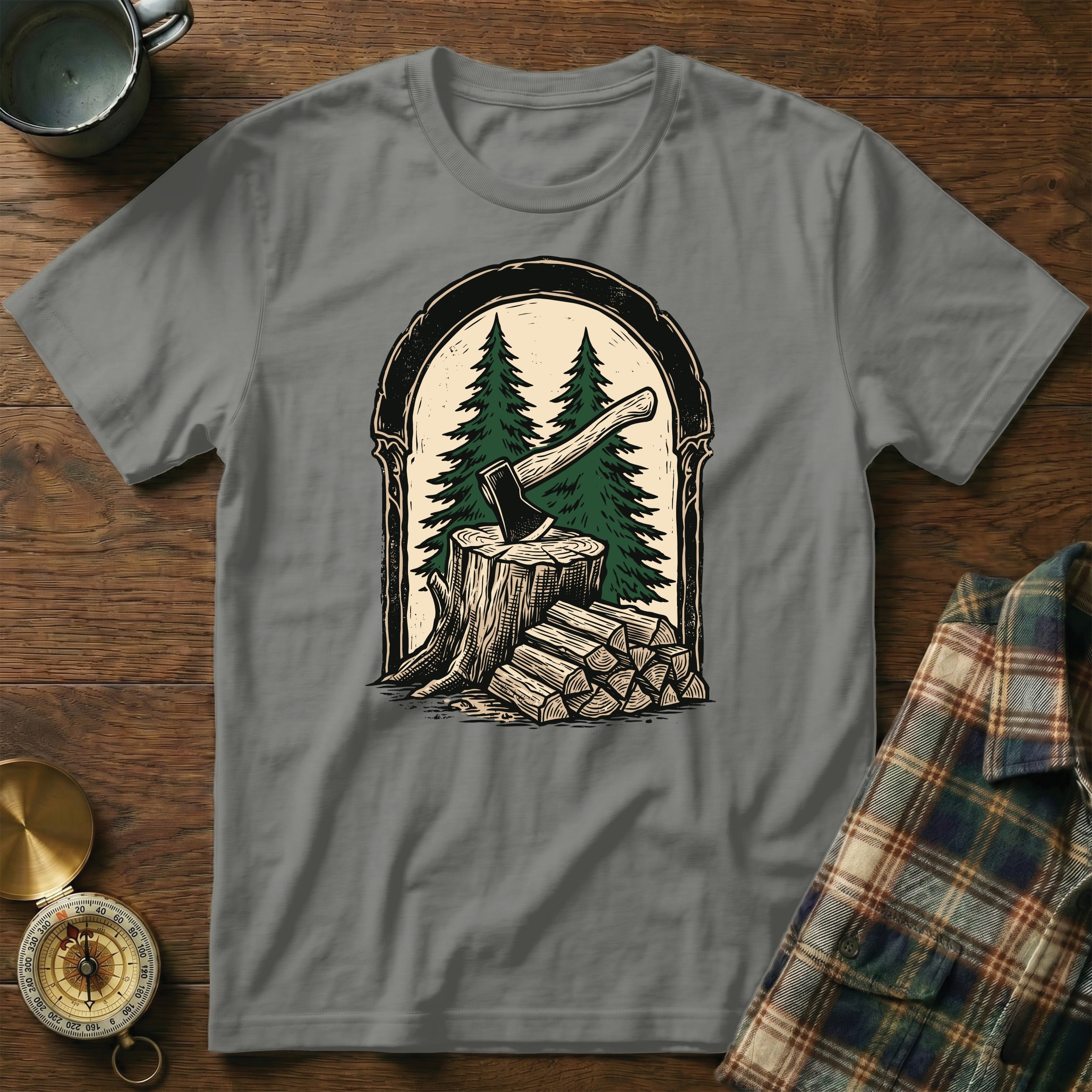 Axe splitting wood in front of pine trees within an arched border.