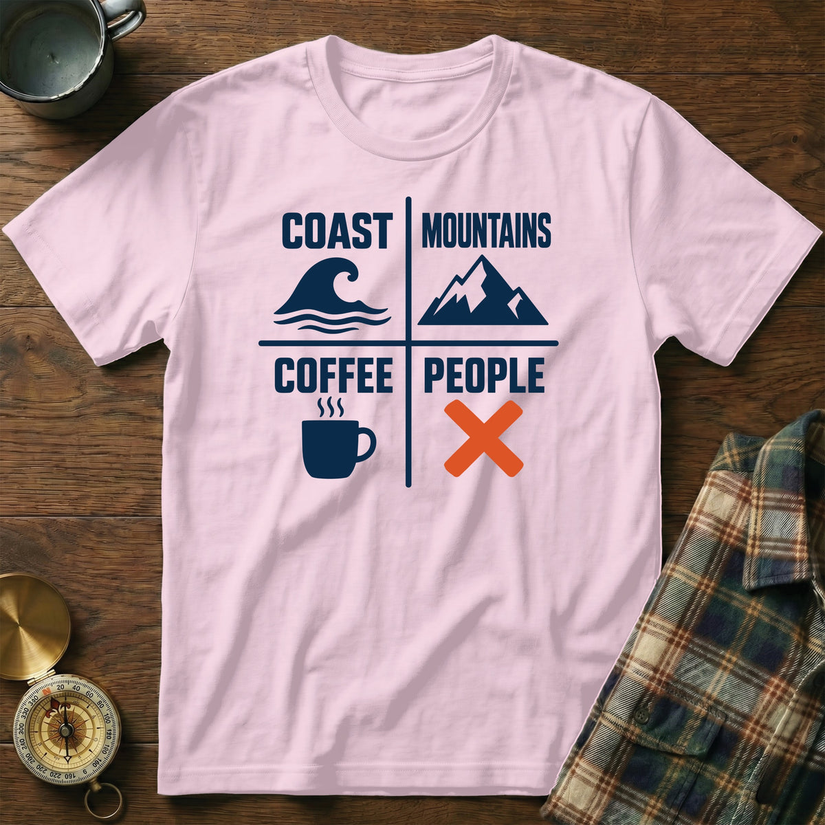 Pink t-shirt with text "Coast Mountains Coffee People" and icons for waves, mountains, coffee, and an X.
