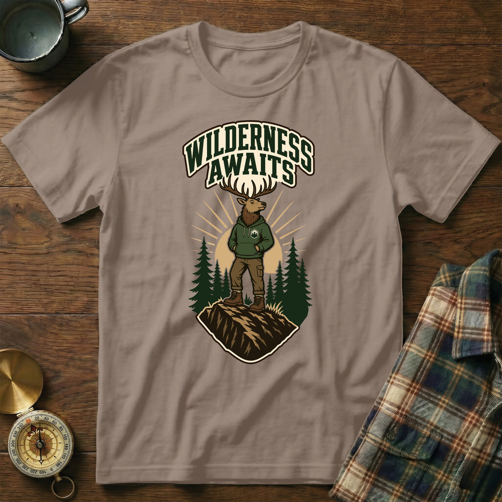 T-shirt with elk graphic and text "WILDERNESS AWAITS" on a mountain.