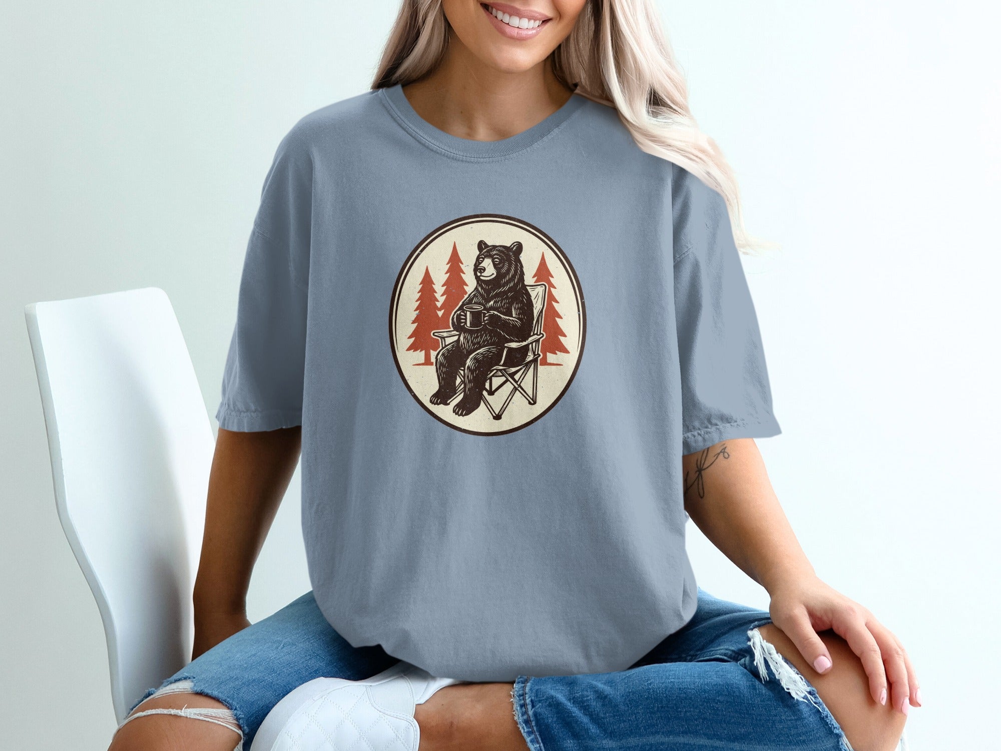T-shirt with a circular graphic featuring a bear sitting in a camp chair holding a mug.