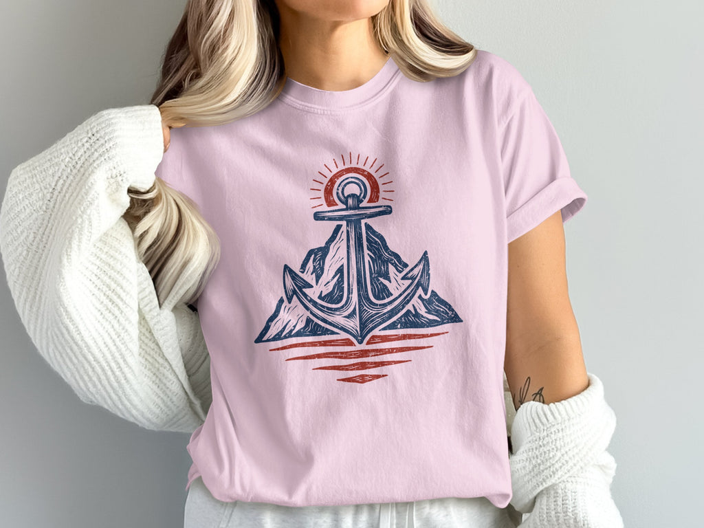 Pink t-shirt with a graphic of an anchor over mountains and sun.