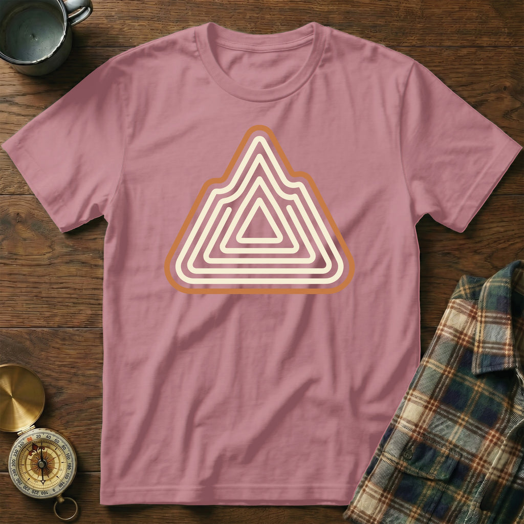 Pink t-shirt with a layered mountain graphic in cream and orange.