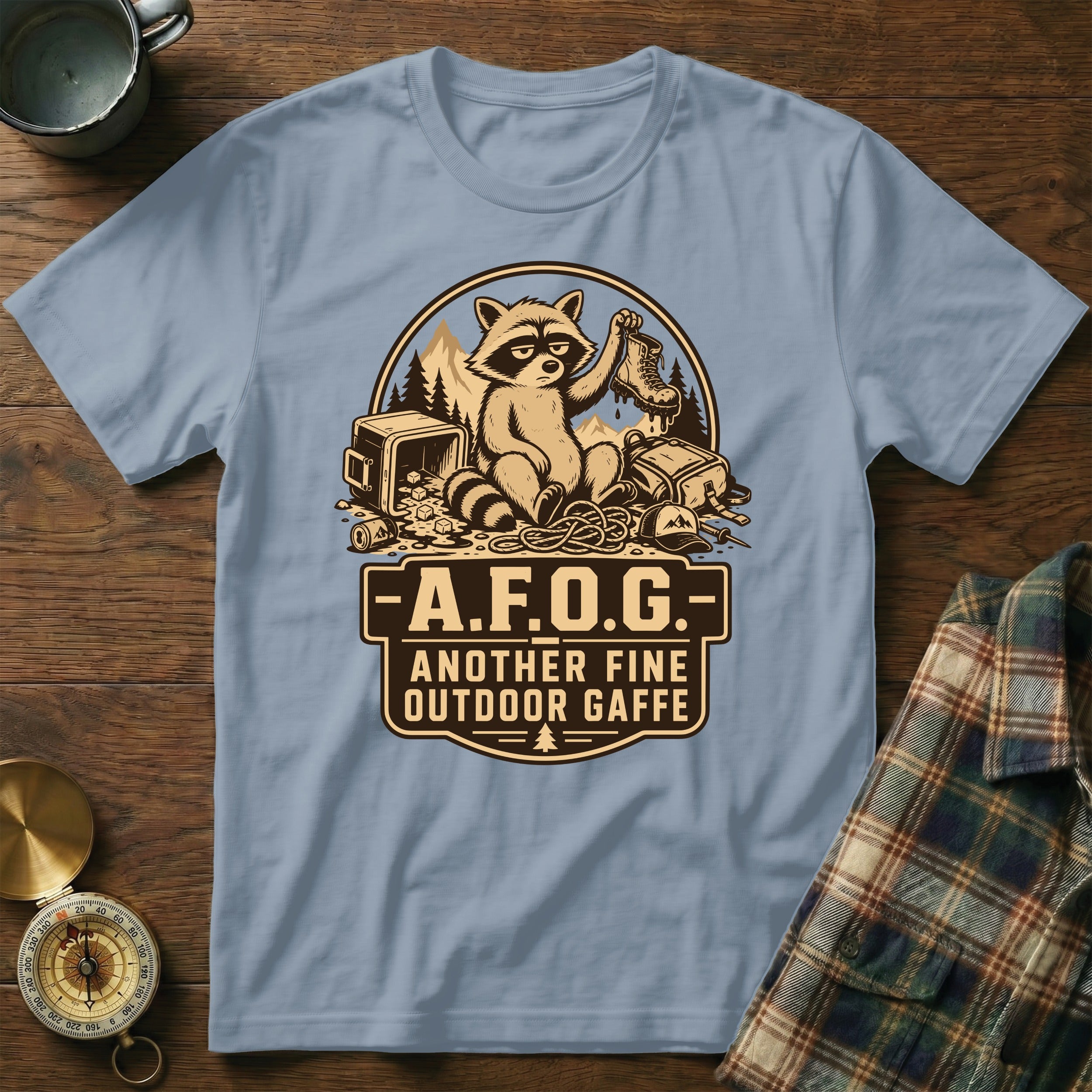 T-shirt with raccoon holding boot and text "A.F.O.G. Another Fine Outdoor Gaffe".