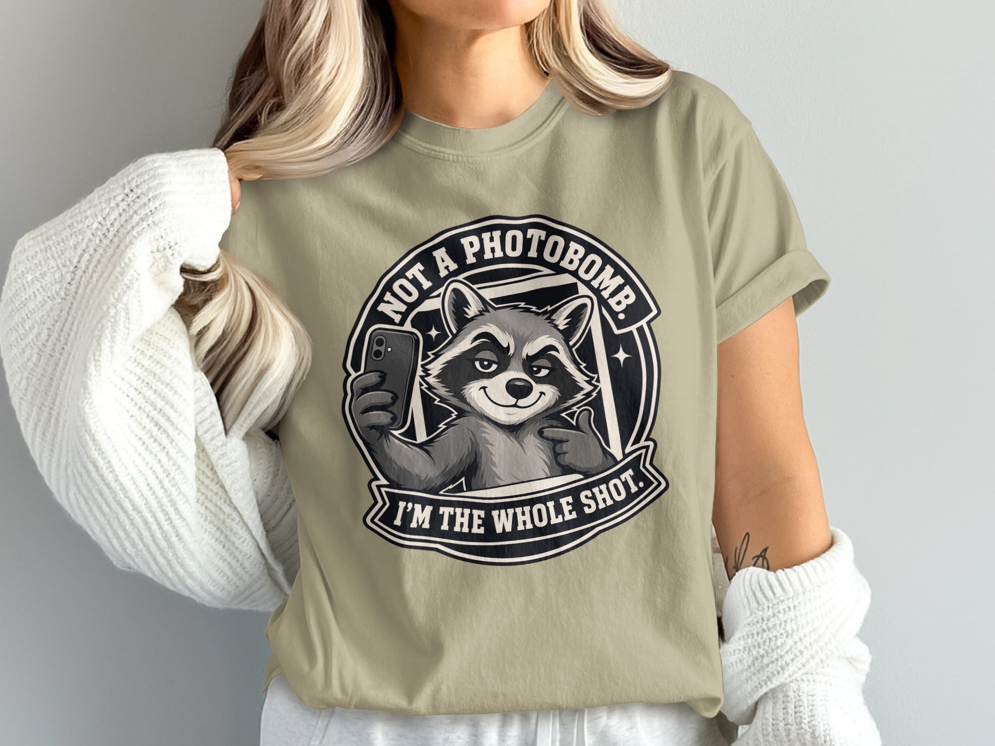 T-shirt graphic featuring a raccoon taking a selfie with text "NOT A PHOTOBOMB. I'M THE WHOLE SHOT."