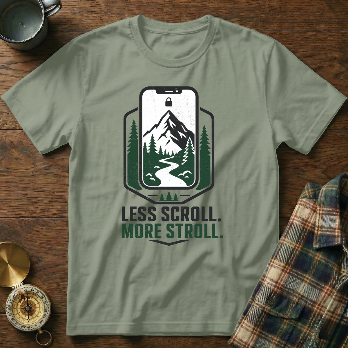 T-shirt with phone graphic, mountains, and text "LESS SCROLL. MORE STROLL."