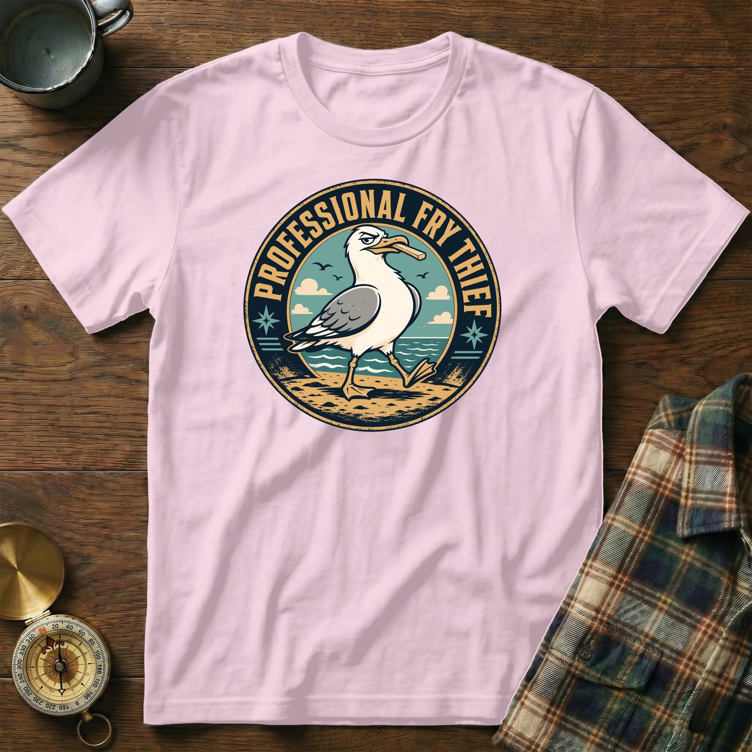 Pink t-shirt with graphic of a seagull holding a fry, text reads "Professional Fry Thief".