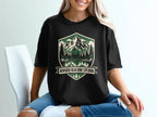 Black t-shirt with a nature scene graphic and text "NOWHERE NEAR DONE EXPLORING".