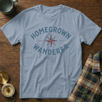 Light blue t-shirt with "HOMEGROWN WANDERER" text and compass graphic.