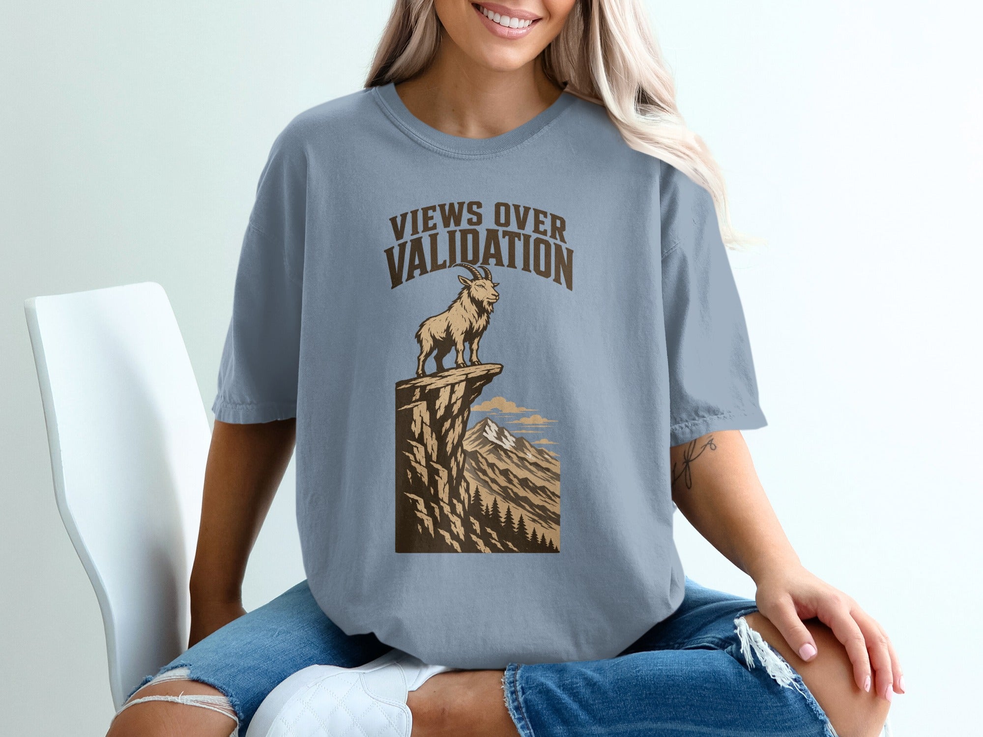 Shirt with "Views Over Validation" text and a mountain goat on a cliff.