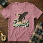 Pink t-shirt with a stylized whale jumping through ocean waves.