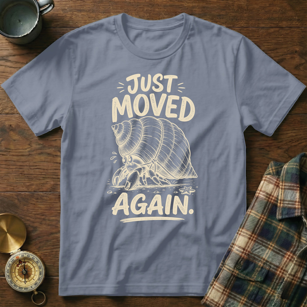 T-shirt with hermit crab graphic and text "JUST MOVED AGAIN".