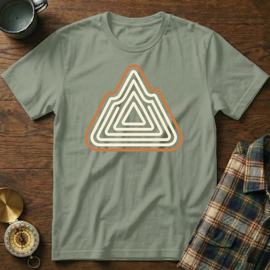 Green t-shirt with a concentric mountain graphic and compass.