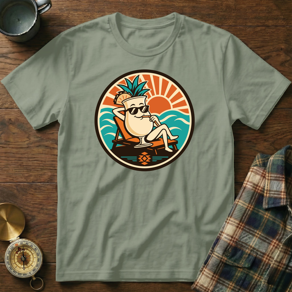 T-shirt with a cartoon cocktail character relaxing by the ocean.