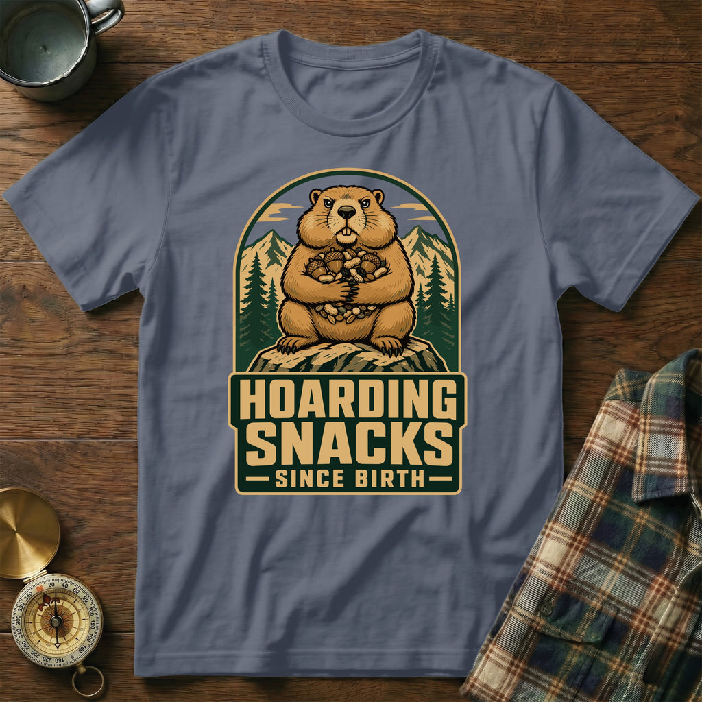 Groundhog holding a pile of nuts with text "Hoarding Snacks Since Birth".