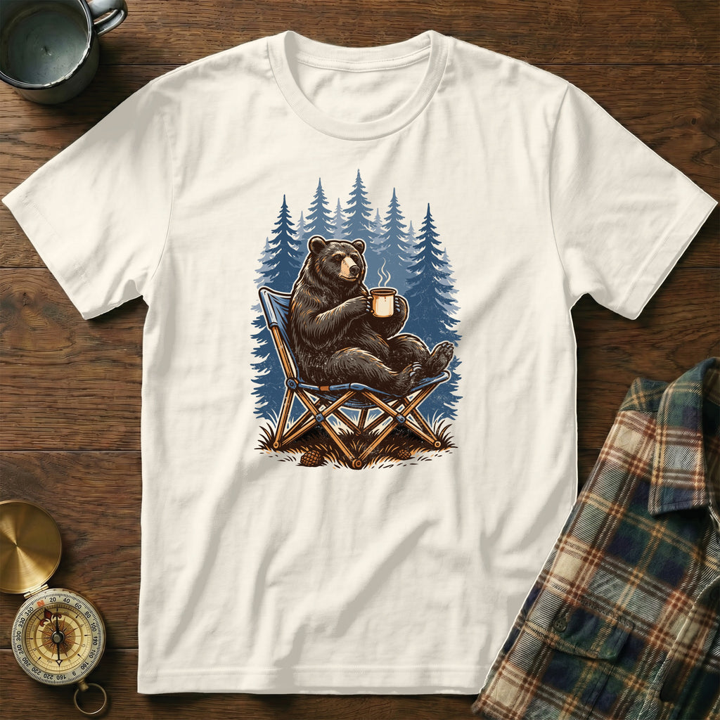 Bear sitting in chair with coffee mug in pine forest graphic on t-shirt.