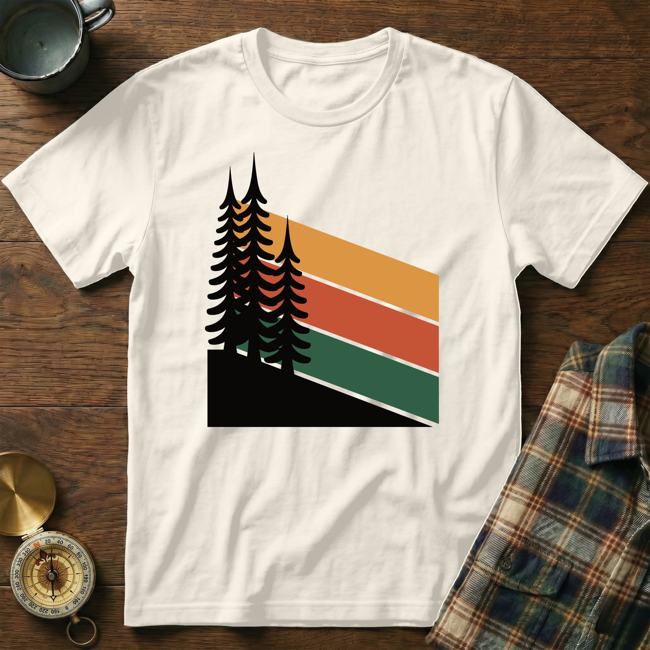 Cream t-shirt with abstract geometric forest design and colorful stripes.
