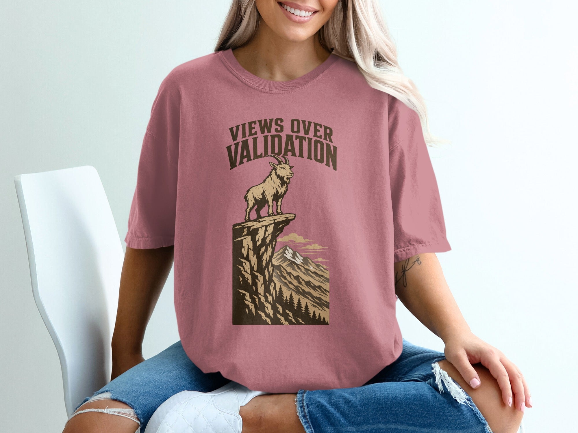T-shirt with "Views Over Validation" text and mountain goat graphic.