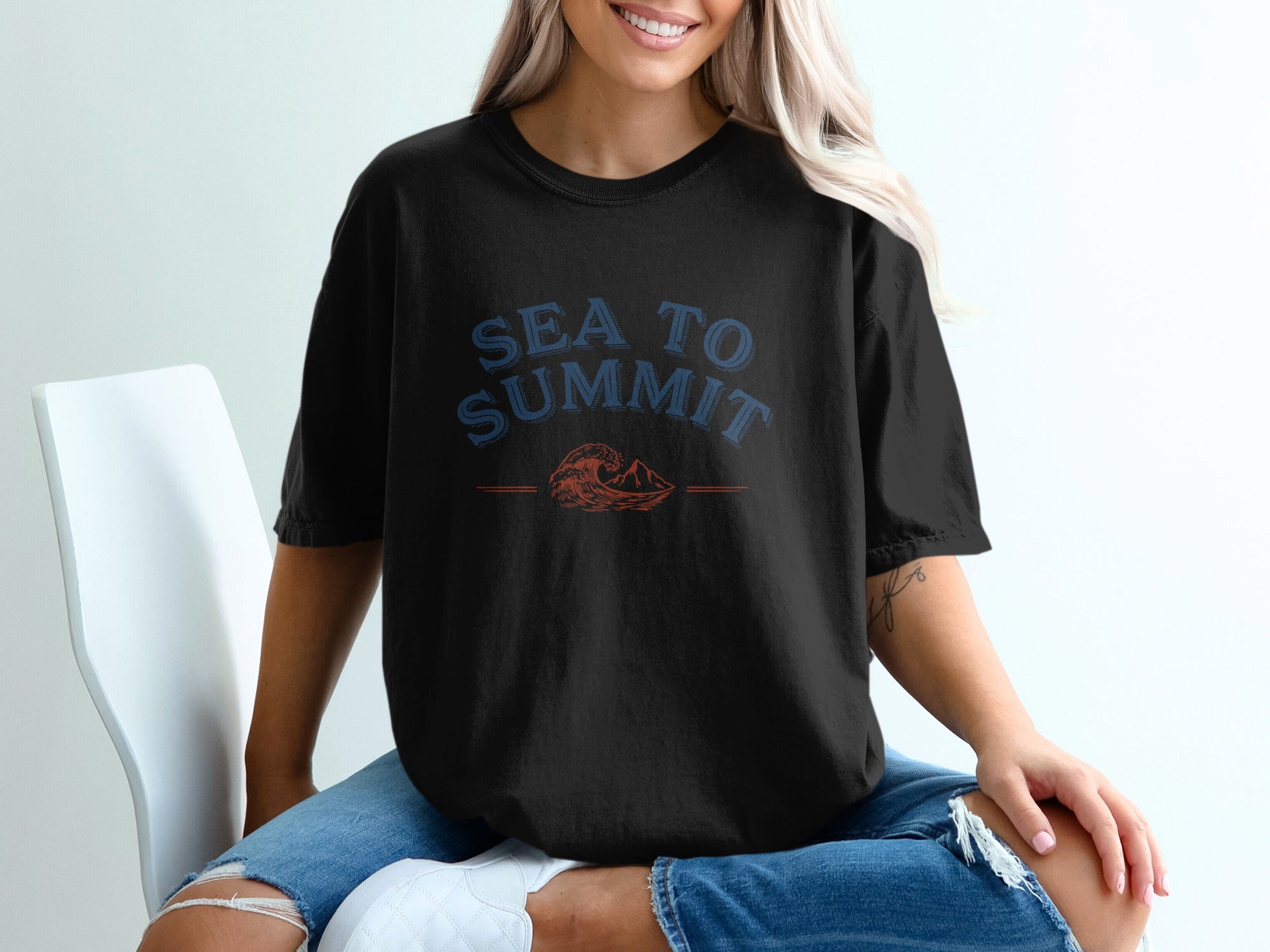 Black t-shirt with "SEA TO SUMMIT" text and wave and mountain graphic.