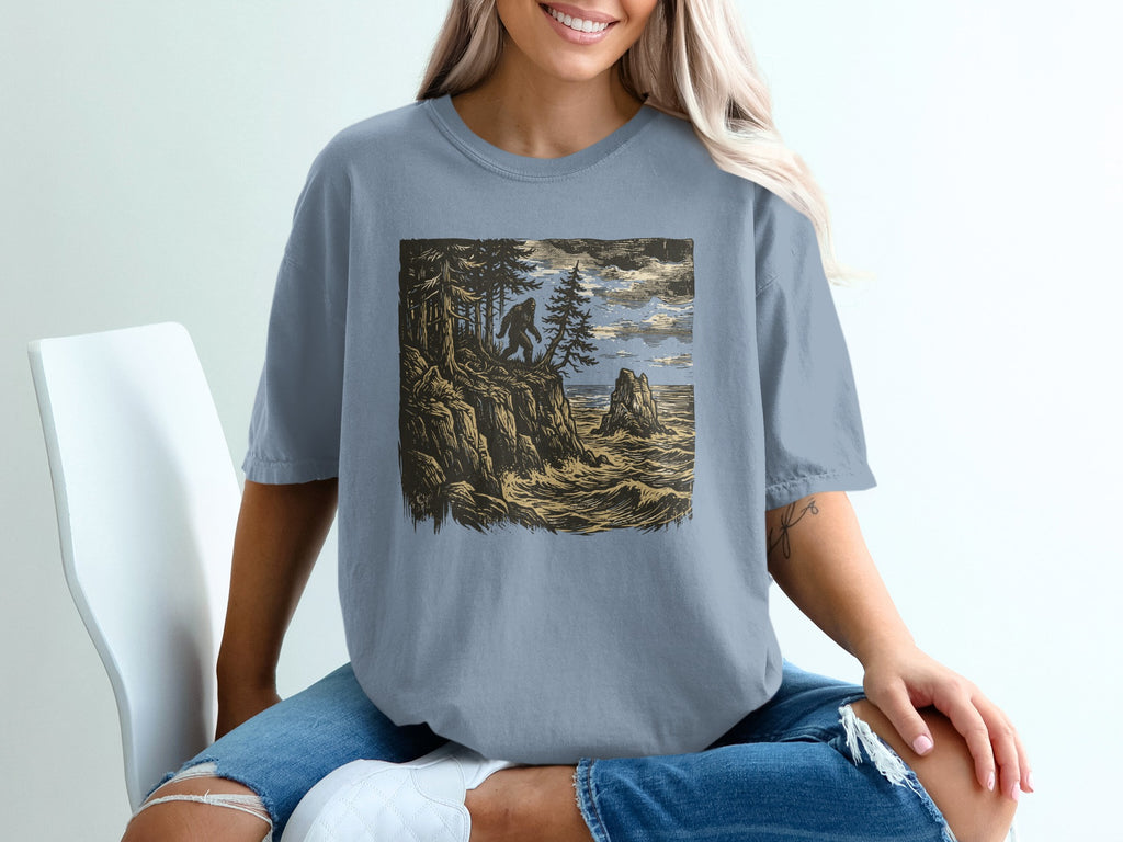 Bigfoot stands on a cliff overlooking a rough ocean with trees.