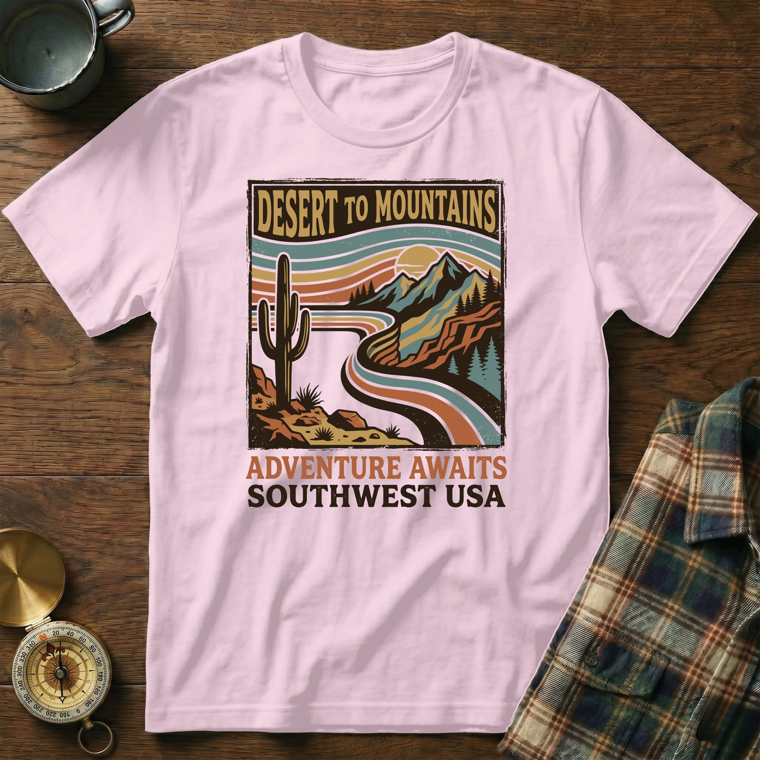 Pink t-shirt with desert mountains graphic and "Adventure Awaits Southwest USA" text.