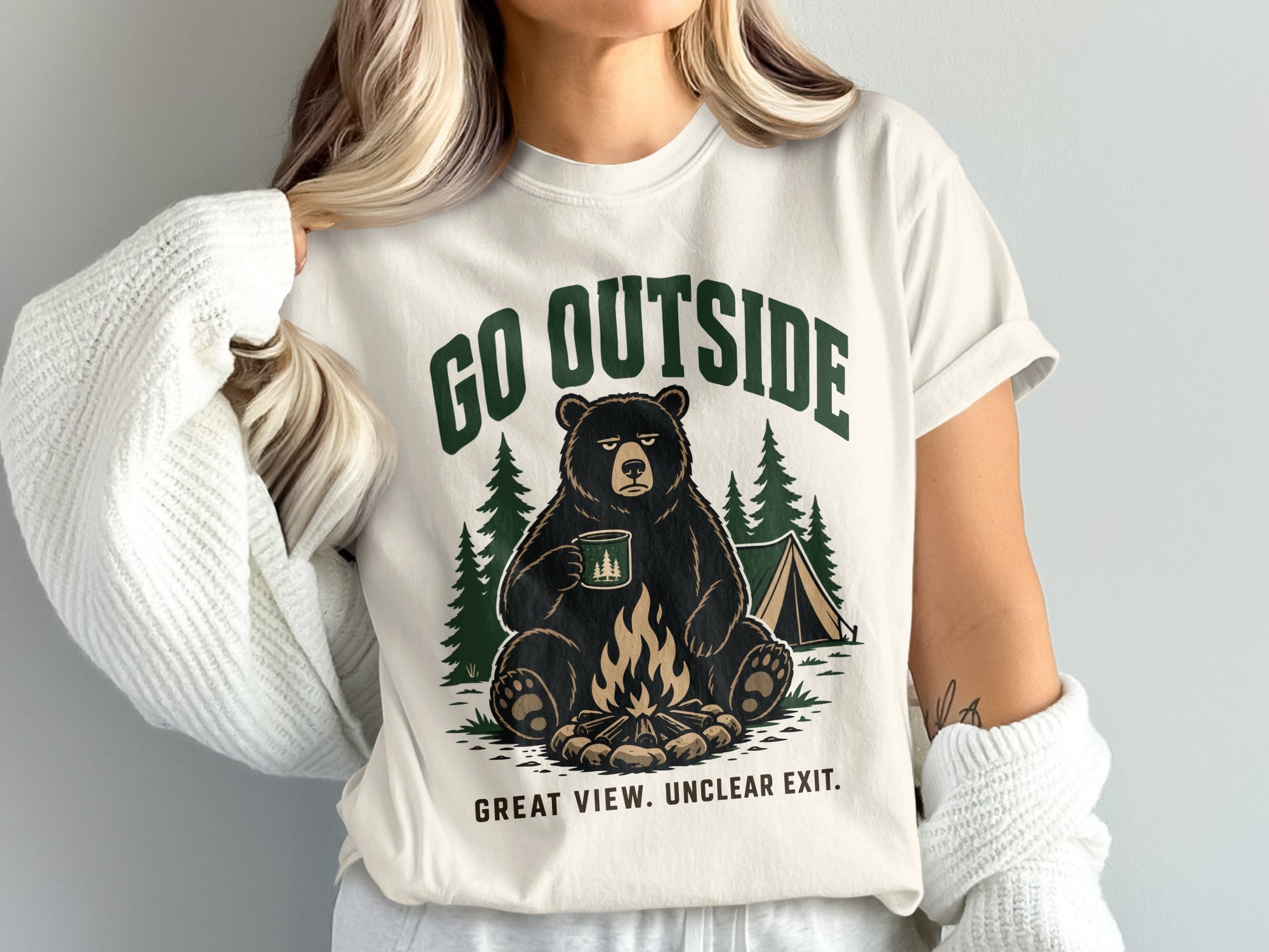 Graphic t-shirt with bear by campfire, tent, and text "GO OUTSIDE" and "GREAT VIEW. UNCLEAR EXIT."