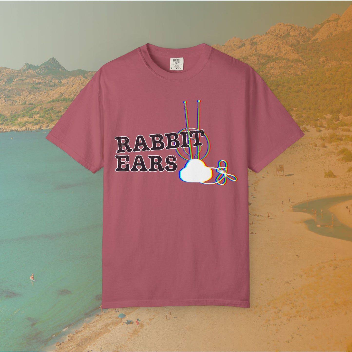 maroon t-shirt distressed EDM music festival text "RABBIT EARS" next to a graphic of a vintage TV antenna and cloud shape with a red, green, and blue (RGB) chromatic aberration/glitch effect, with an RGB shift design