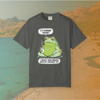 Funny T-shirt graphic featuring a large, grumpy toad holding a to-go coffee cup. The cartoon is captioned with the quotes: "IT'S MONDAY AGAIN? I WASN'T EVEN FINISHED WITH MY SATURDAY YET.
