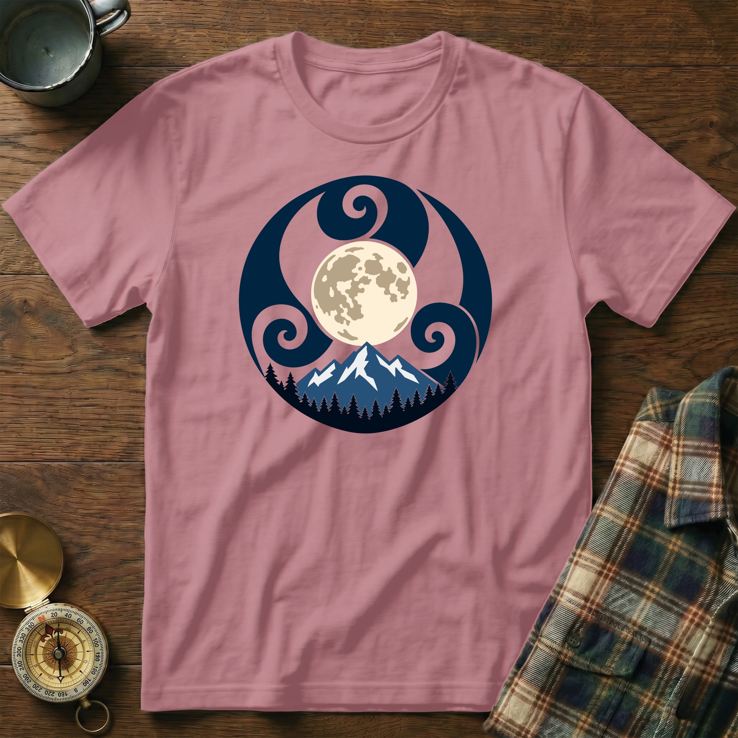 Pink t-shirt with a round graphic of a full moon over snowy mountains and trees.