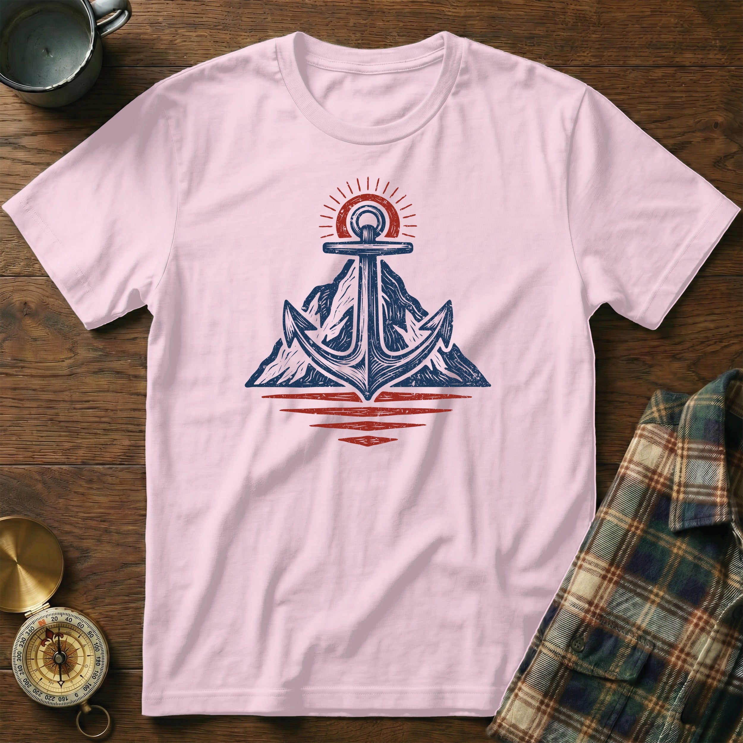 Light pink t-shirt with anchor, mountain, and sun graphic in navy and red.