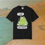 Black T-shirt Funny T-shirt graphic featuring a large, grumpy toad holding a to-go coffee cup. The cartoon is captioned with the quotes: "IT'S MONDAY AGAIN? I WASN'T EVEN FINISHED WITH MY SATURDAY YET.