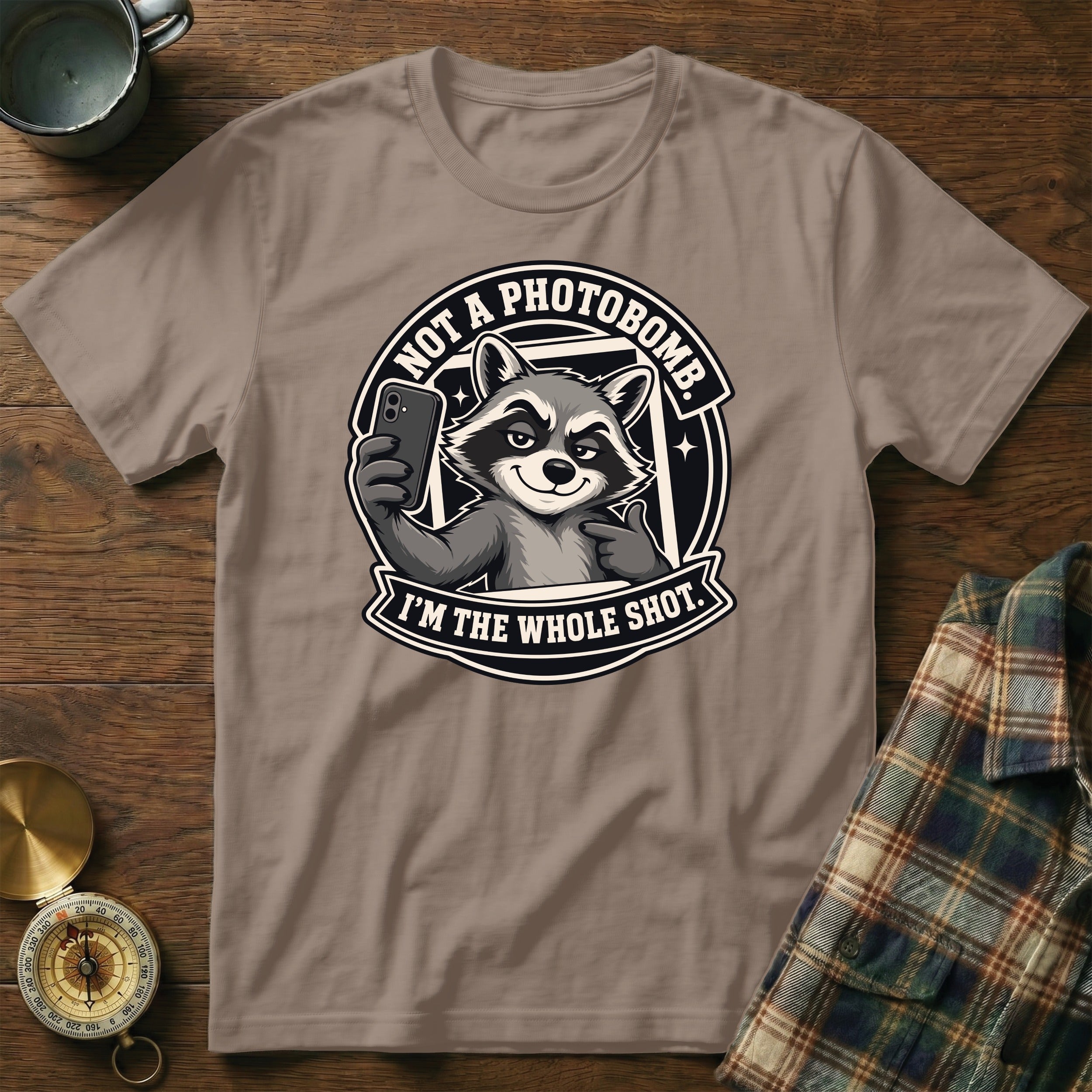 T-shirt features a raccoon holding a phone with text, "NOT A PHOTOBOMB. I'M THE WHOLE SHOT."