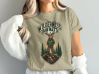 T-shirt graphic with elk and "Wilderness Awaits" text.